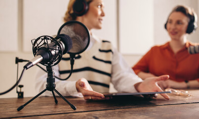 Wall Mural - Two women recording a podcast in a home studio