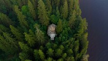 Ancient Wooden Church Among Dense Green Forest Trees, Woods, Top View From Drone, Copter, Zooming In