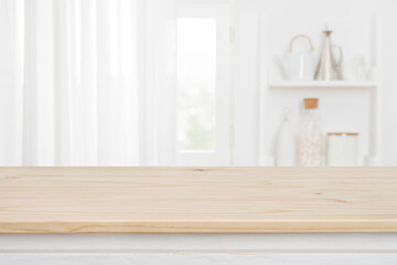 Wood table on blur kitchen window background for product montage