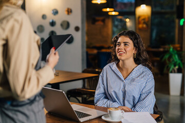 Young employer talks to employee