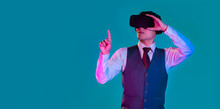 Asian Man In White Shirt Red Tie Wearing Vr Goggles Headset Watching And Finger Poiting And Touching Blue Color Background. Metavers Concept