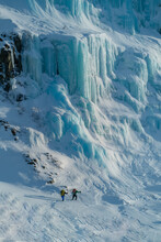 Ice Climbers Hiking Towards Ice Wall In Swedish Lapland, Stora Sjöfallet National Park, Sweden