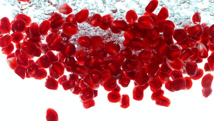 Poster - Fresh pomegranate pieces falling into water, super slow motion filmed on high speed cinematic camera at 1000 fps