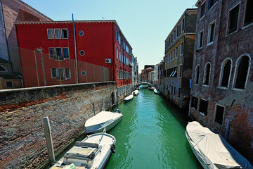 Canal with boats in Venice, Italy.