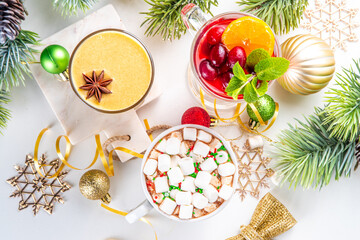 Wall Mural - Set of traditional Christmas winter drinks. Christmas bar menu background.Tree cup with mulled wine, eggnog, hot chocolate beverages om white table with Christmas, New Year decorations, copy space