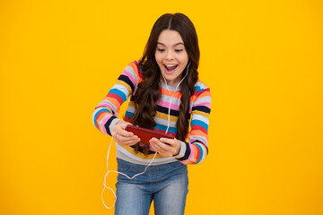 Poster - Amazed girl 12, 13, 14 years old with smart phone. Hipster teen girl types text message on cellphone, enjoys mobile app. Kid hold smartphone texting in online social media. Excited teen girl.