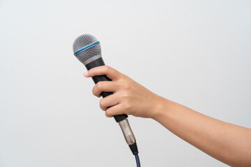 Woman hand holding microphone on white background