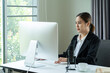 © littlestocker - Asian woman working on desktop computer