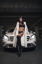 Attractive Brunette In Underwear And Trench Coat Near Her White Car