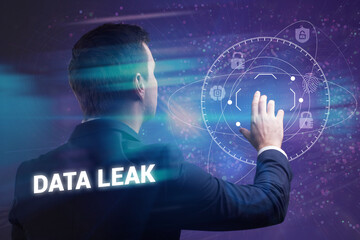 Wall Mural - Business, Technology, Internet and network concept. Young businessman working on a virtual screen of the future and sees the inscription: Data leak