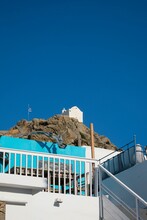 Vertical Shot Of The White Church On The Rock With Blue Sky In Background