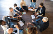 © Vittorio Gravino - Team of multiracial people discussing about new project on the floor of the office. Business start-up concept