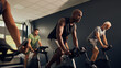 © Flamingo Images - Man cycling during a class at the gym