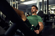 © Flamingo Images - Man exercising his legs on a weight machine