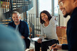 © Flamingo Images - Group of diverse businesspeople laughing together in an office meeting