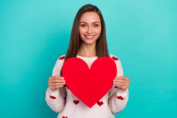 Wall Mural - Photo of positive adorable lady hands hold big red paper heart card isolated on emerald color background