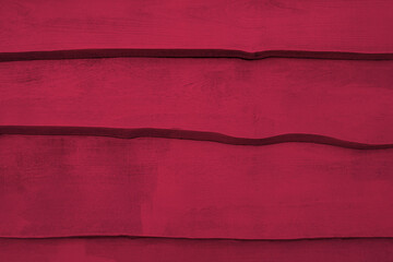 Wooden background in viva magenta color, which is the color of the year 2023.