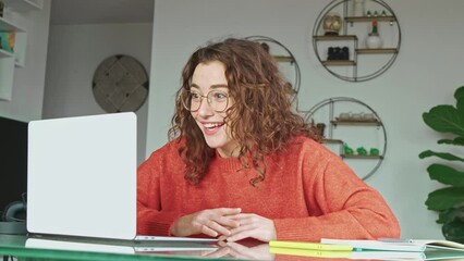 Wall Mural - Young happy woman office worker student feeling excited winning online scholarship, looking at laptop celebrating professional achievement, receiving good online exam results or getting hired at work.