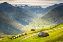 Swiss Train In The Idyllic Alps Around Andermatt, Uri, Switzerland