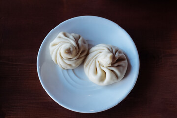 two khinkali on a plate on the table