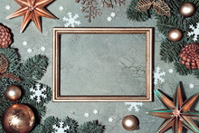 Christmas Background. Flat Lay With Fir Twigs Decorated With Red Rowan Berry, Paper Stars And Snowflakes On Grey Green Textured Background. Copy-space, Place For Text In Metallic Copper Frame.