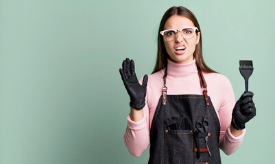 Wall Mural - young pretty woman screaming with hands up in the air. hair dryer concept