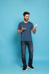 Poster - Handsome man having video chat on phone against light blue background