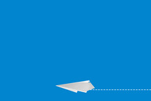 Handmade White Paper Plane On Blue Background. Space For Text