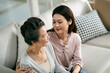 © imtmphoto - asian adult daughter and senior mother chatting at home