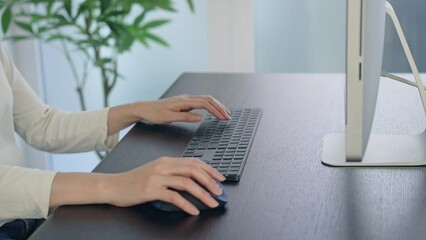 Aufkleber - Close-up of a woman's hand using a desktop computer in the office.