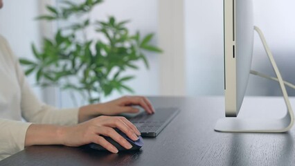 Aufkleber - Close-up of a woman's hand using a desktop computer in the office.