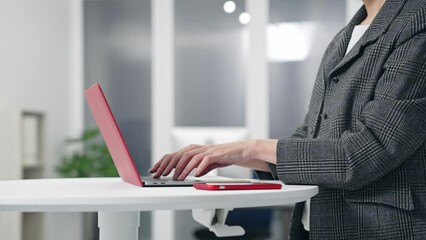 Aufkleber - Woman using smartphone and laptop in office.