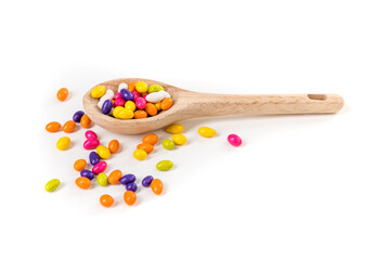 Sticker - Fennel seed candy scattered around a wooden spoon isolated over white