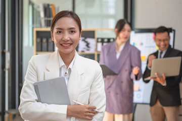 Marketing, Financial, Accounting, Planning, Asian businesswoman team leader with beautiful leaves smiles showing joy after successful company work.