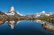 Mountains of the Alps and the Matterhorn reflecting on the water of a lake