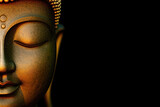 Rock buddha statue on black background, carved buddha portrait