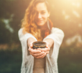 Poster - Cacao ceremony, heart opening medicine. Ceremony space. Cacao cup in woman's hand.