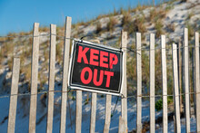 Destin, Florida- Keep Out Sign On A Fence With Wood Connected By A Stainless Steel Wires