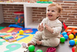 © Krakenimages.com - Adorable redhead toddler sitting on floor applauding at kindergarten