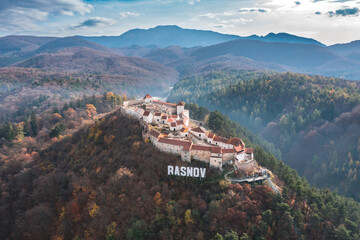 Wall Mural - Aerial view with Rasnov fortress, the famous medieval landmark in Carpathian Mountain Brasov Romania