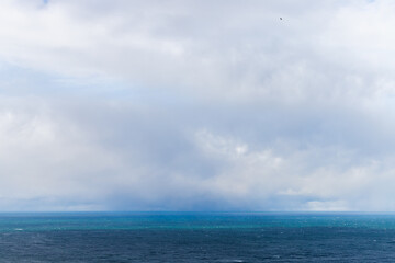 Wall Mural - blue baltic sea water is under cloudy sky on a c cloudy day