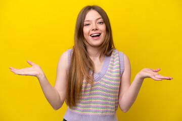 Wall Mural - Young caucasian woman isolated on yellow background with shocked facial expression