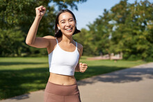 Happy Fitness Girl Achieve Goal, Finish Marathon, Running With Hands Up, Celebrating Victory While Jogging, Triumphing In Park