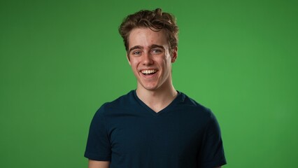 Portrait of smiling happy young hipster man 20s in slow motion isolated on solid yellow background with copy space in studio