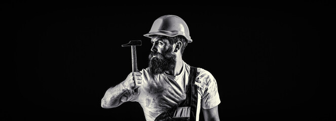 Wall Mural - Bearded man worker with beard, building helmet, hard hat. Hammer hammering. Builder in helmet, hammer, handyman, builders in hardhat. Black and white