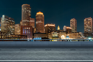 Empty urban asphalt road exterior with city buildings background. New modern highway concrete construction. Concept of way to success. Transportation logistic industry fast delivery. Boston. USA.