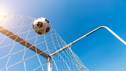 Wall Mural - Football goal net against blue sky