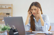 © Pichsakul - Home office concept, Businesswoman stress and headache while thinking marketing plan of startup