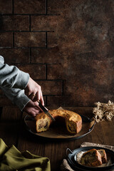 a asian woman cut the marble cake on wood table background