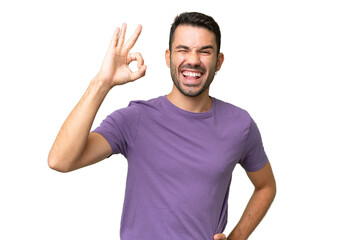 Young handsome caucasian man over isolated background showing ok sign with fingers